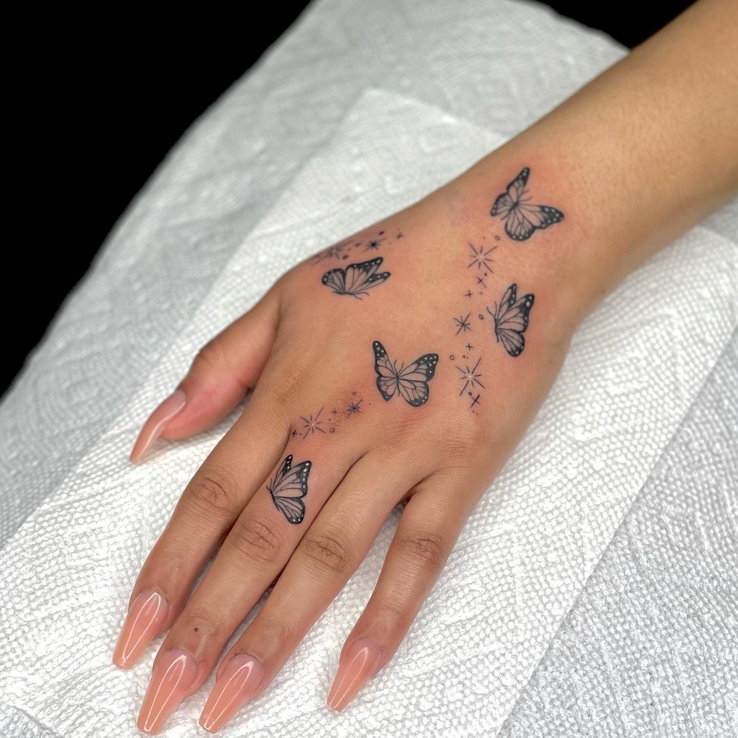 Butterfly hand and finger tattoo